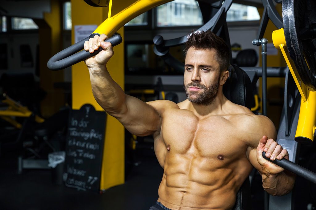 Certified personal trainer guiding client during strength training session