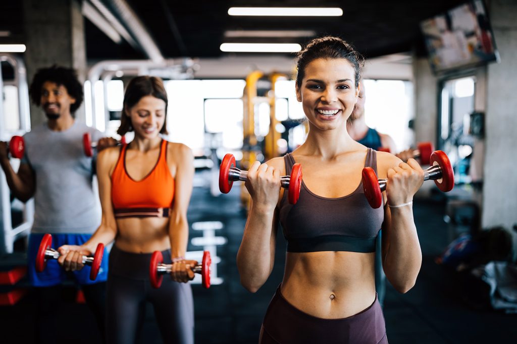 Modern yoga with fitness equipment and people doing workout